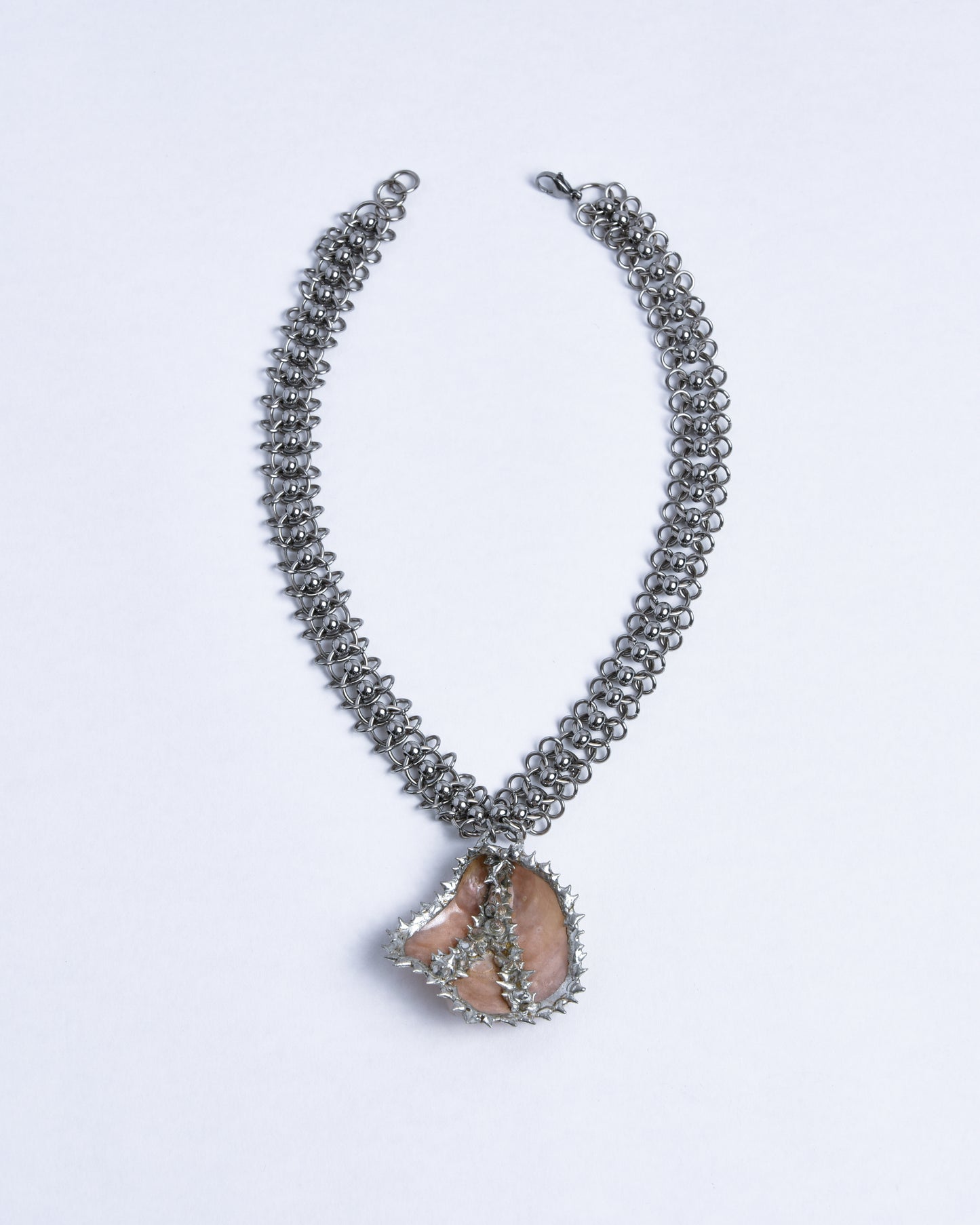 silver stainless steel chainmail necklace with spiky champagne pink mother of pearl sea shell pendant