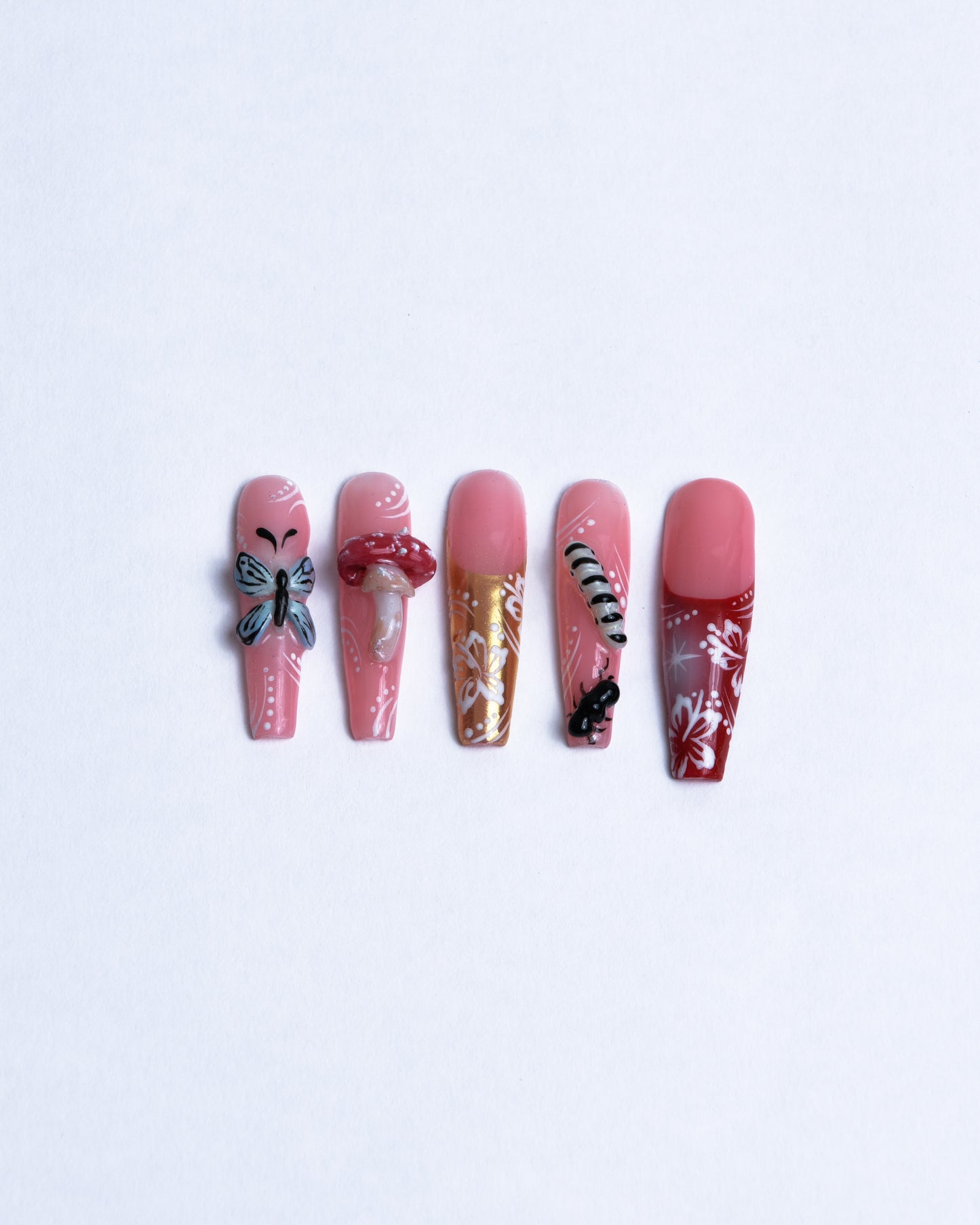 XXL Coffin shaped Hibiscus flowers on gold and red french tips with 3D hand sculpted caterpillar butterfly and red mushroom on sheer rose base