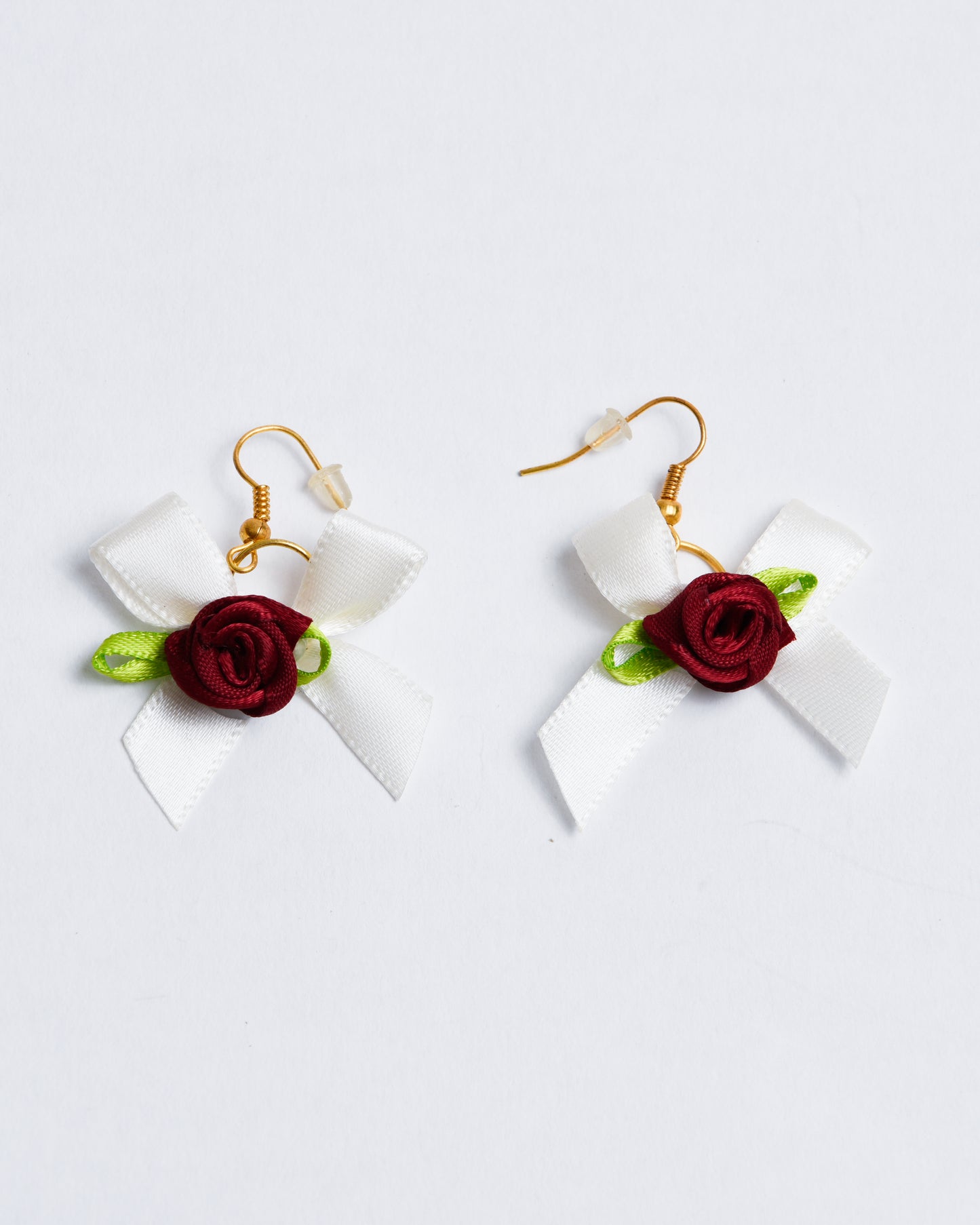 Fabric bows with fabric roses, set on copper earring hangers.