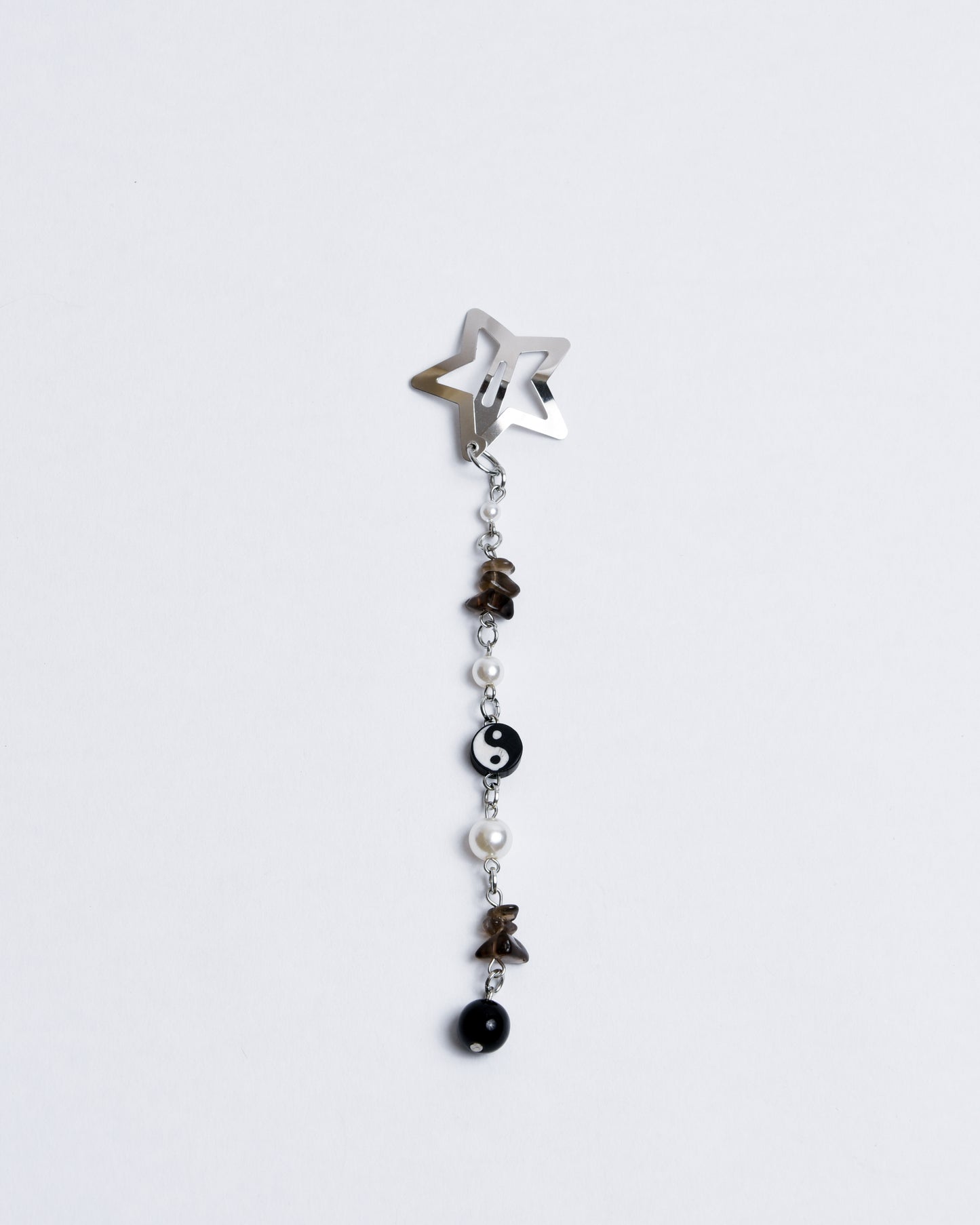 A silver star-shaped clip with beads hanging beneath it in a cascading pattern.
