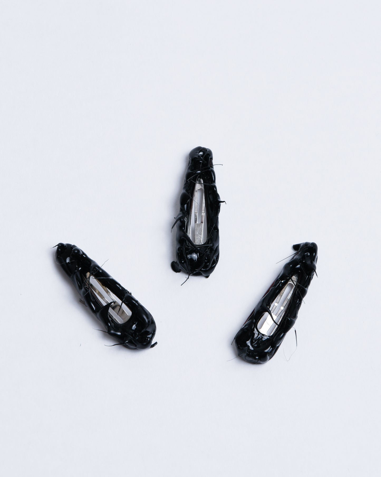 Small black hairclips with gummy texture going up like spikes