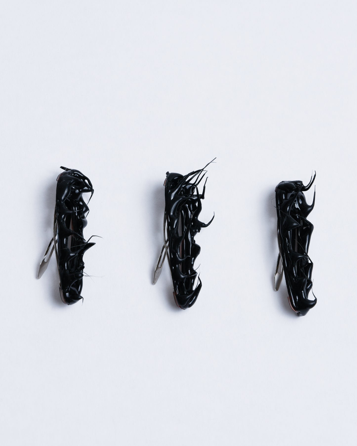 Small black hairclips with gummy texture going up like spikes