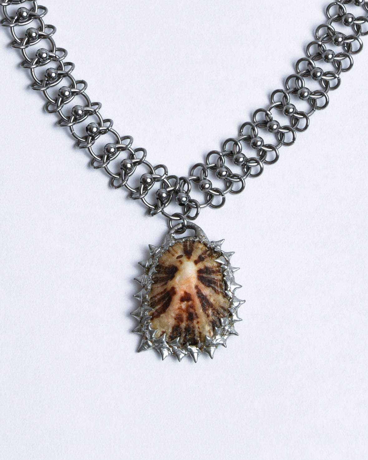 silver stainless steel chainmail necklace with brown limpet shell pendant with silver spikes