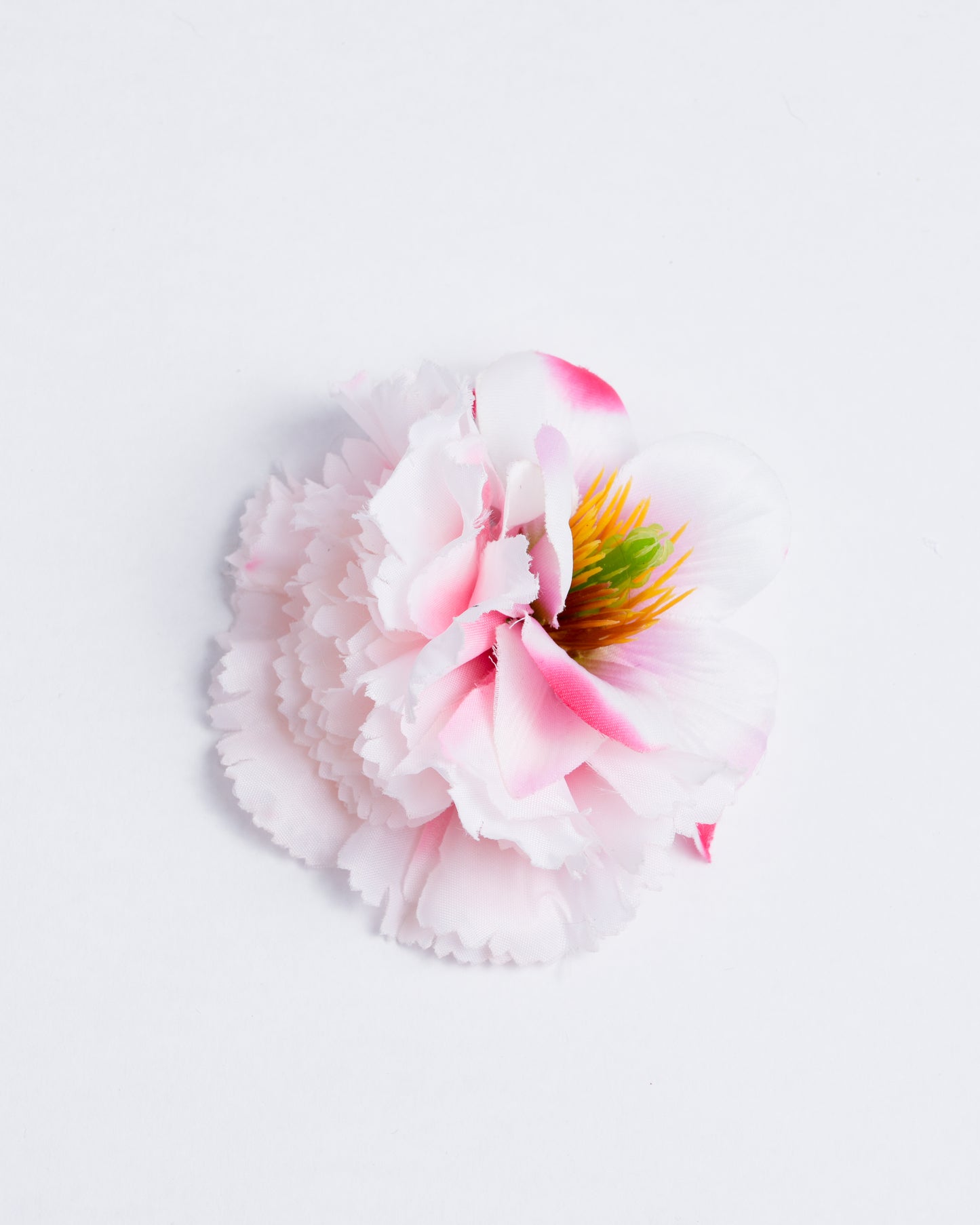 Two different types of synthetic flowers attached to a pin/clip