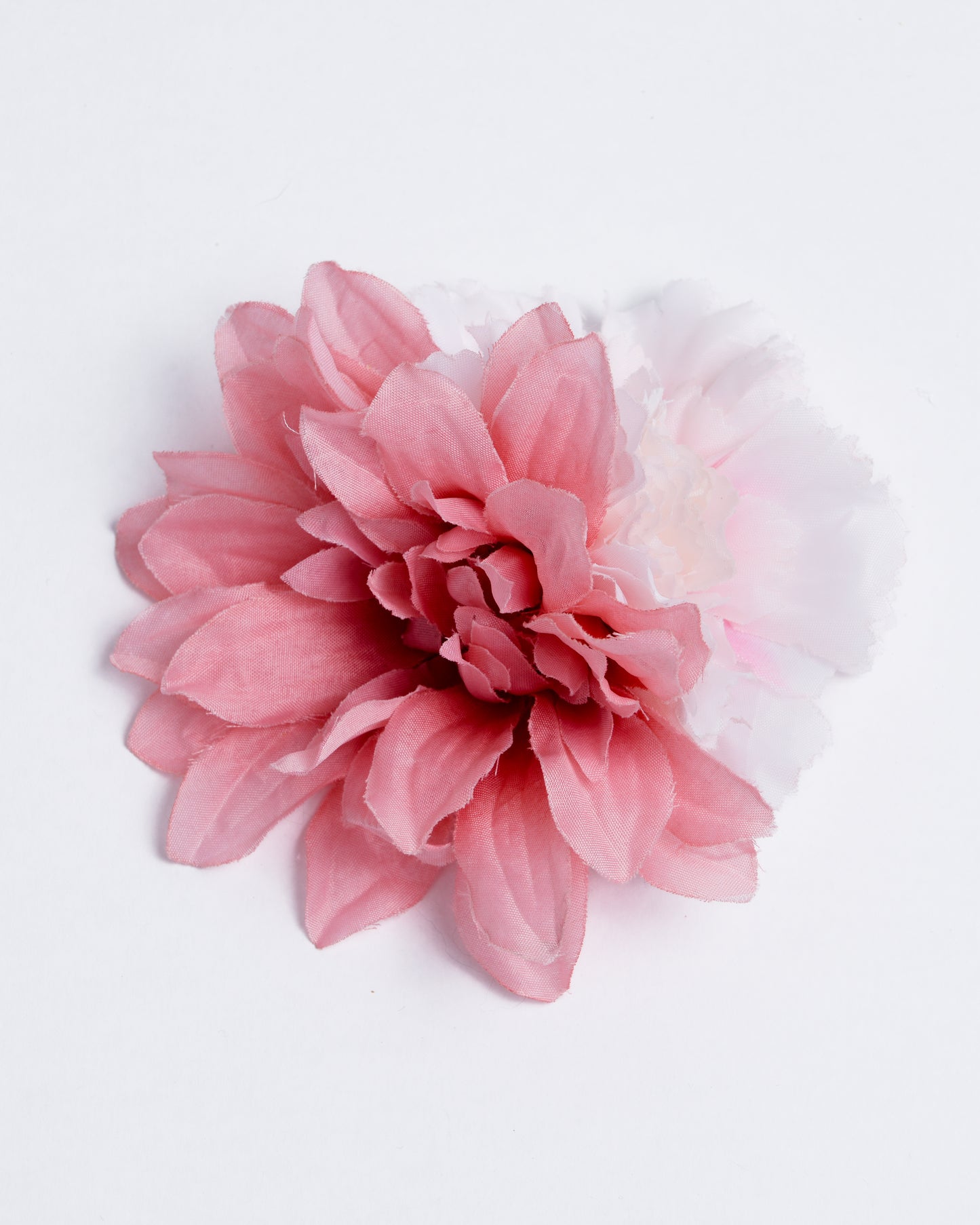 Two different types of synthetic flowers attached to a pin/clip