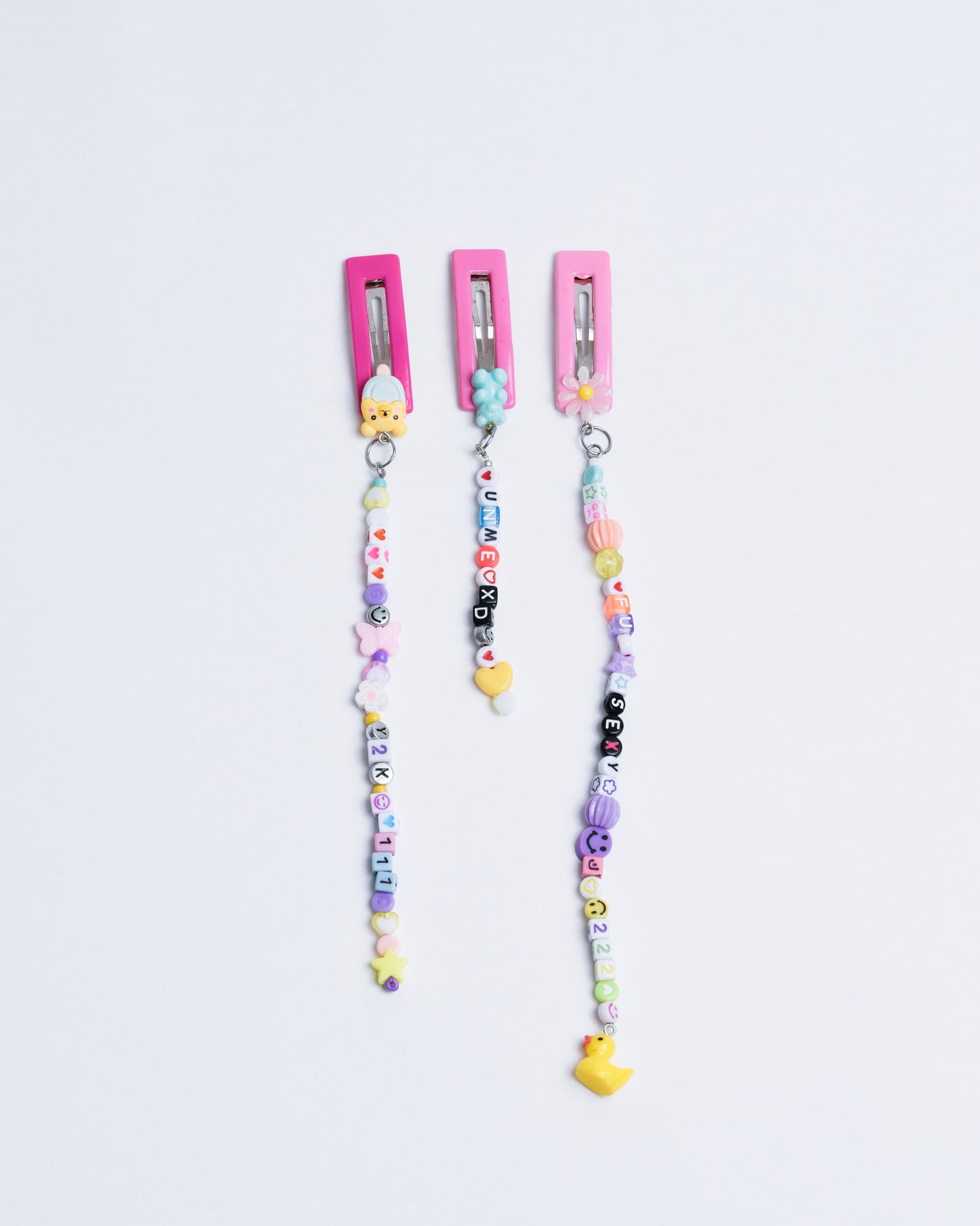 3 pink hairclips in different lengths with cute beads. For example angel numbers, smileys, teddy bears and stars.