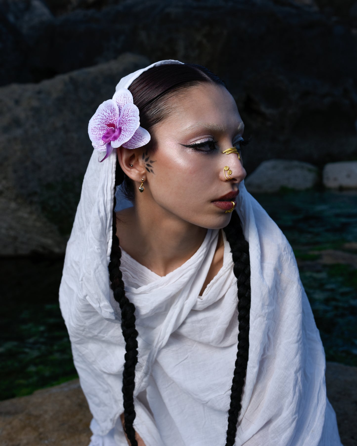 model wearing orchid flower in hair