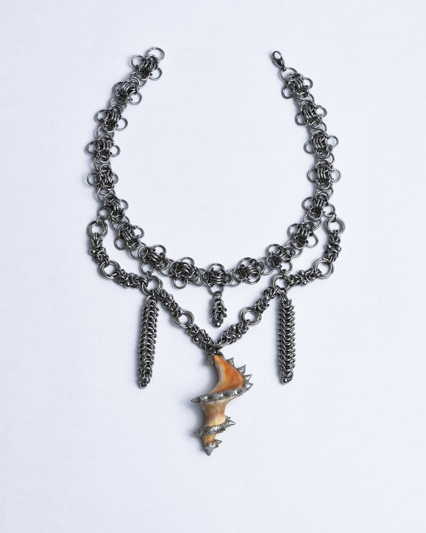 Chainmail choker from silver stainless steel. Pendant is made from middle part of sea snail shell which is orange and cream colored adorned with spikes using silverlead-free Sn99Cu1 soft solder
