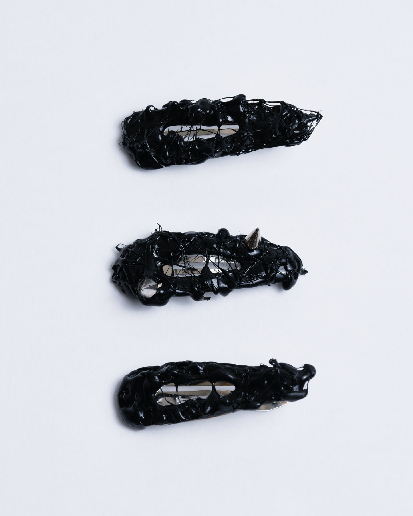 Black hair clip with textured gummy texture and spikes in it