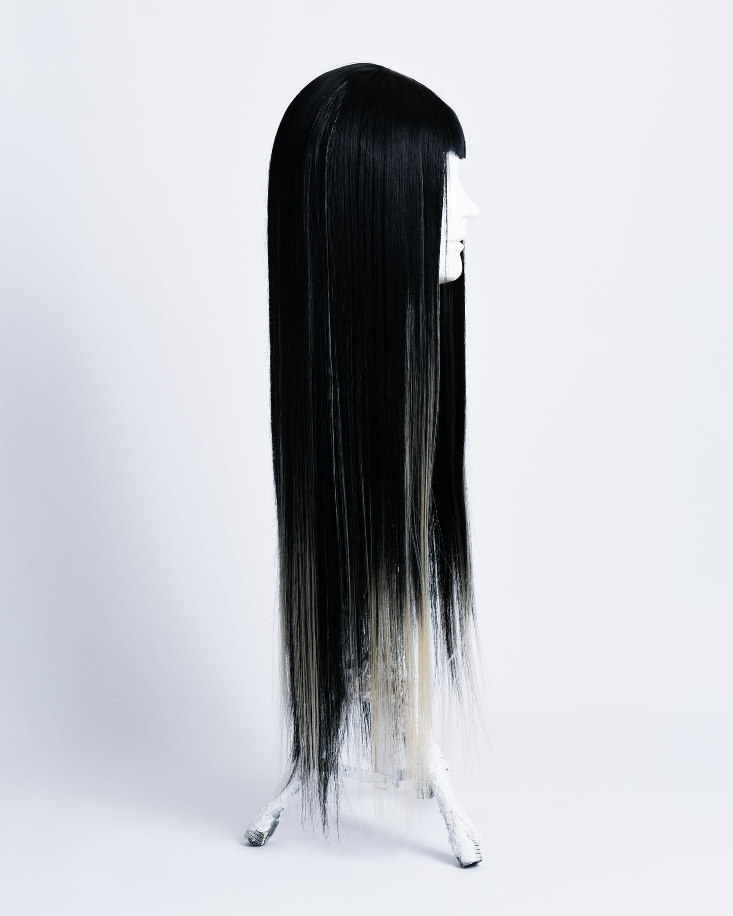 side of wig Alter is a 80cm long synthetic black wig with blonde highlights and short black bangs