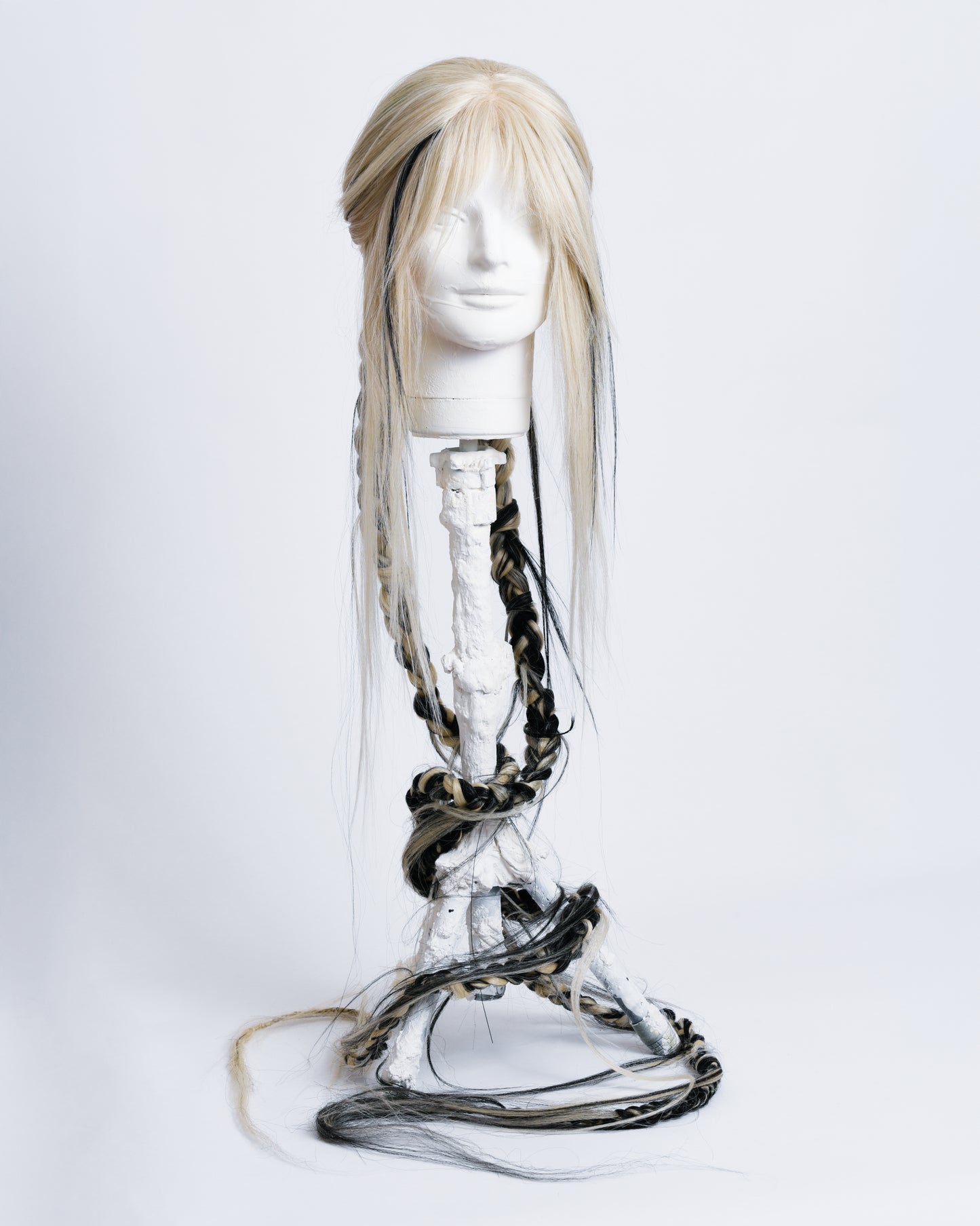 front of Light blonde synthetic wig with black highlights short curtain bangs in the back starting 2 braids there are 2 hair art pieces 2 handcrafted black and blonde hair flowers with a litle black water wave and then two 1,35 long braids with a lot of long hair coming out